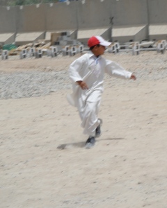 Running soccer player in baseball cap